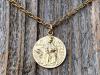 Shiny Gold St Dymphna Medallion dangling on a cable chain necklace